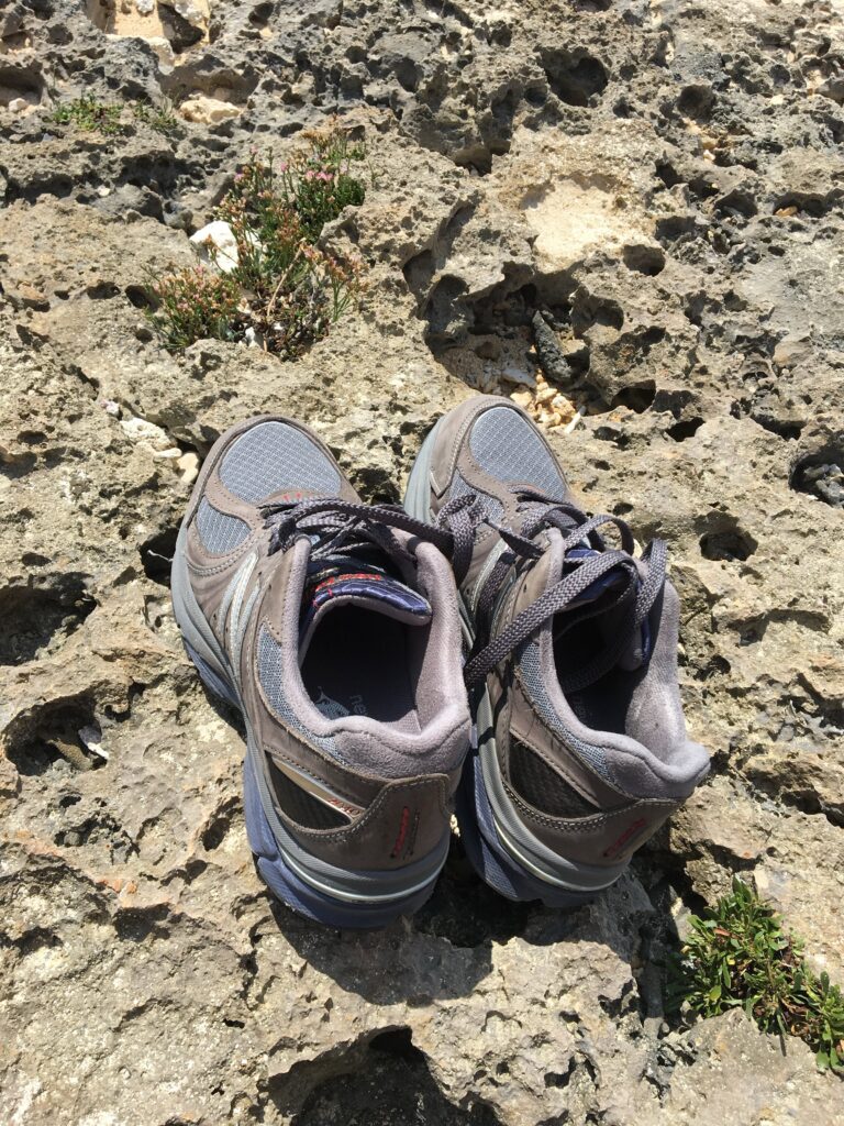 New Balance M2040 V1 sneakers on a rocky beach in Okinawa, Japan