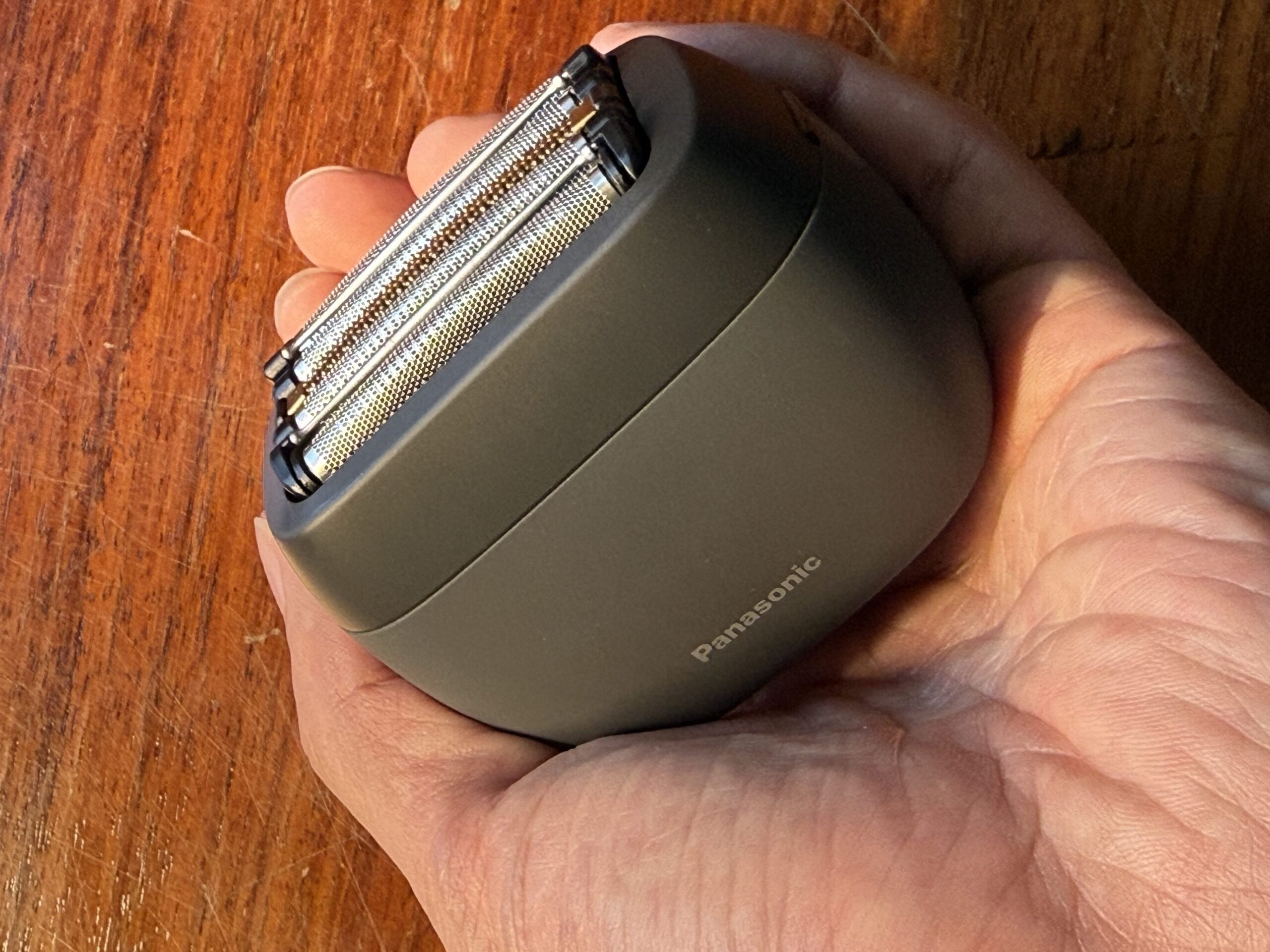 Panasonic LAMDASH PALM IN held in the palm of a hand