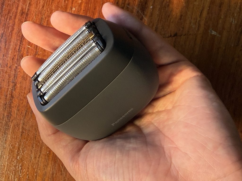 Panasonic LAMDASH PALM IN electric shaver held in the palm of a hand